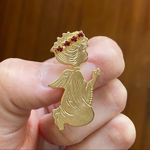 Gold tone metal angel pin with synthetic ruby stones.